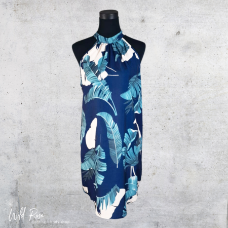 Tropical Navy Leaf Print Halter Dress featuring a blue and white tropical leaf pattern on a navy background.