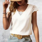 White Lace-Back Bow Blouse featuring delicate lace cap sleeves, a flattering V-neckline and elegant lace detailing, styled with light blue jeans.