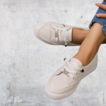Ladies blush-pink casual sneakers with lace-up fastening, metallic accents, and textured soles by WildRose.