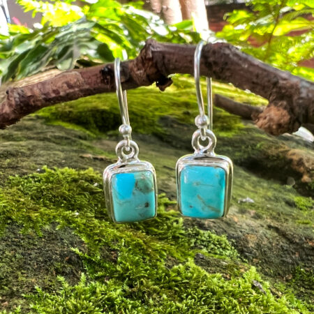 Add a beautiful pop of colour to your jewellery collection with these Turquoise Square Drop Earrings. Featuring striking turquoise-coloured stones in a simple square shape, these earrings combine a fresh, natural-inspired look with elegant silver-toned detailing. The square stones create a modern silhouette, while the delicate drop design adds movement and a feminine finishing touch. The vibrant turquoise shade makes these earrings especially eye-catching and easy to use as a statement accessory. Perfect for adding colour to everyday outfits, the Turquoise Square Drop Earrings can also be styled for special occasions, holidays or summer looks. Pair them with a simple blouse, flowing dress or casual outfit to let the beautiful turquoise stones stand out. Product Features - Beautiful turquoise-coloured stones - Classic square shape - Elegant drop design - Silver-toned detailing - Eye-catching, nature-inspired colour - Lightweight-looking, delicate style - Versatile for everyday or occasion wear The Turquoise Square Drop Earrings are a lovely choice for anyone who enjoys colourful, distinctive jewellery with a simple and elegant design.