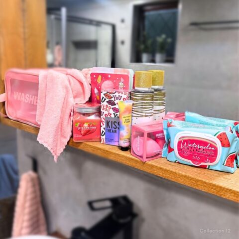 Collection 12 pamper gift set featuring a pink wash bag, soft towel and a selection of colourful beauty, skincare and self-care essentials.