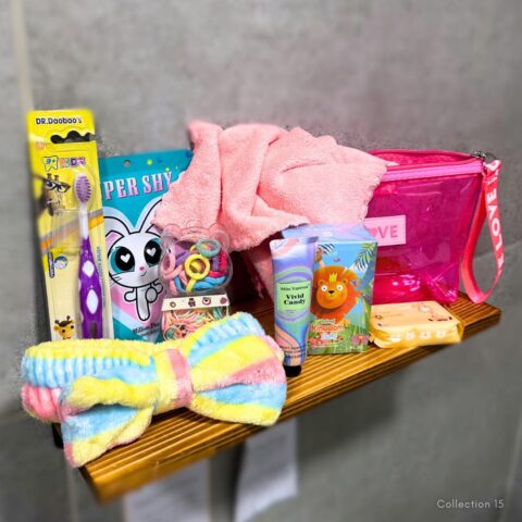 The Little Luxe Toddler Pamper Set with luxury bag, mini refresh wipes, perfume, soft face cloth, hair bands, face mask, hand cream, plush headband and kiddies toothbrush.