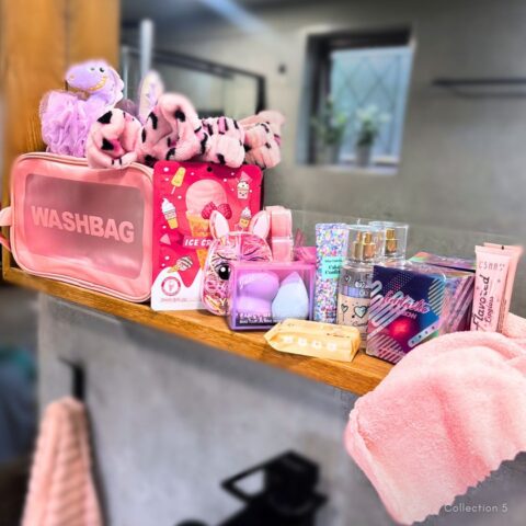 The Teen Pamper Collection Collection 05 featuring a luxury bag, Royale Essence perfume, Sweet Glow body spray, hair bands, plush headband, Dino wash sponge, face cloth, pink lip balm, hand cream, face mask, makeup sponge set and refresh wipes.