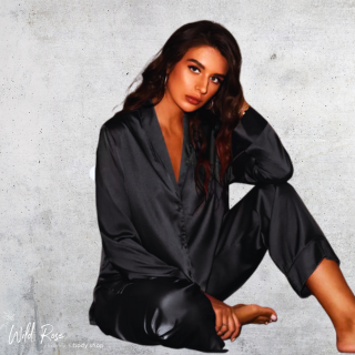 Ladies Silk Winter Pajamas in black with a long-sleeved button-up top and matching full-length pants, modelled by a woman.