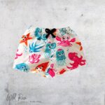Ocean Friends Swim Shorts featuring colourful octopuses, jellyfish, crabs and other sea creatures on a white background, perfect for kids' swimming and beach days.