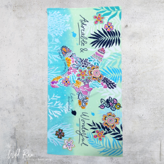 Starfish Microfibre Beach Towel featuring a colourful starfish decorated with vibrant flowers and tropical foliage on a turquoise and mint-green background.