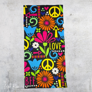 Funky Microfiber Beach Towel featuring colourful flowers, peace signs, hearts and playful patterns on a black background, perfect for beach days and swimming.
