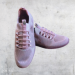 Ladies pink Hush Puppies sneakers featuring breathable mesh detailing and distinctive loop-style lace-up fastening.
