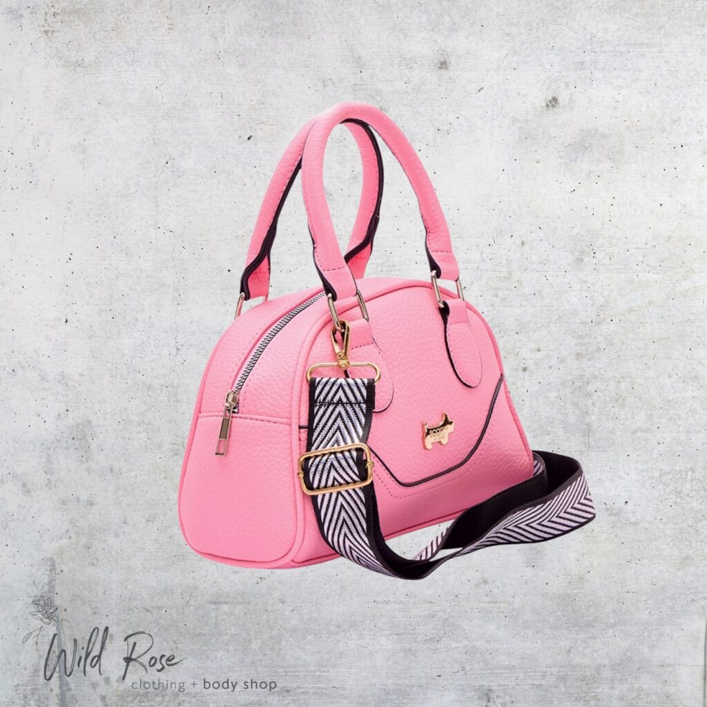 Pink Lemonade Bag by Scotty Bags & Co. featuring a bright pink handbag, black-and-white patterned shoulder strap and elegant gold-tone details.