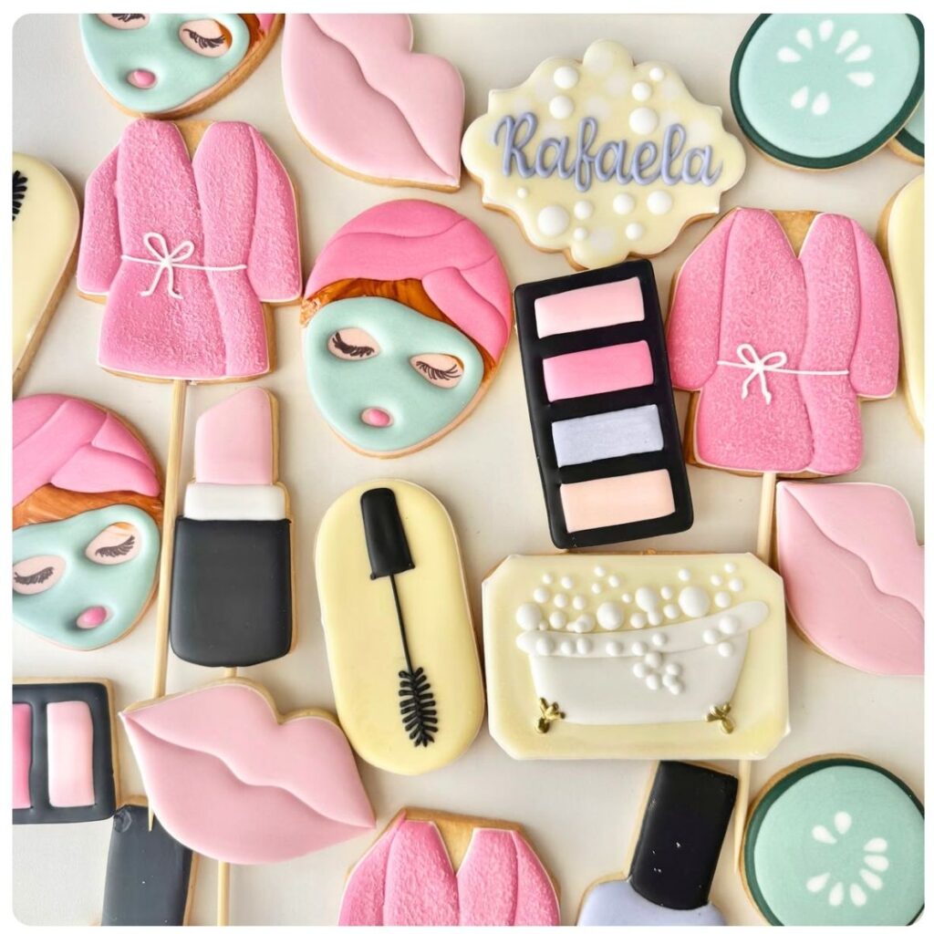 Yummy Treats Decorated Themed Cookies featuring pastel pink, mint green and white icing in beauty and spa-inspired designs, including makeup, lipstick and face mask shapes.