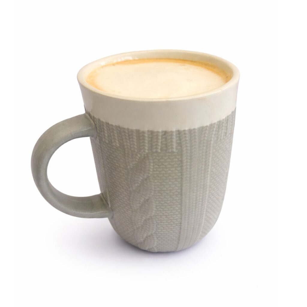 Party Bites Cappuccino served in a grey ceramic mug with creamy frothy coffee on a white background.