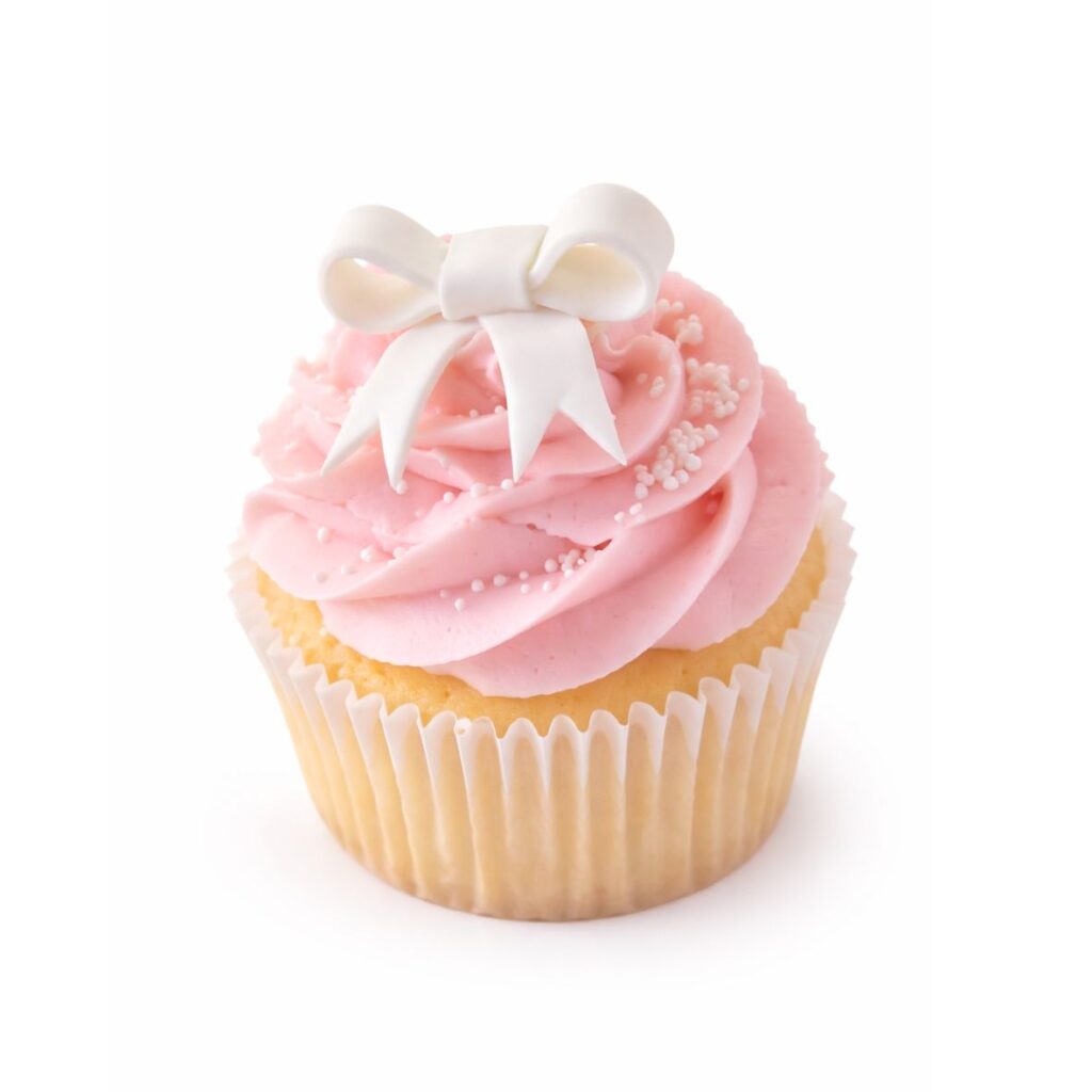 Yummy Treats Minimal Cupcake with pink swirled frosting, delicate sprinkles and a white bow decoration in a cupcake liner.