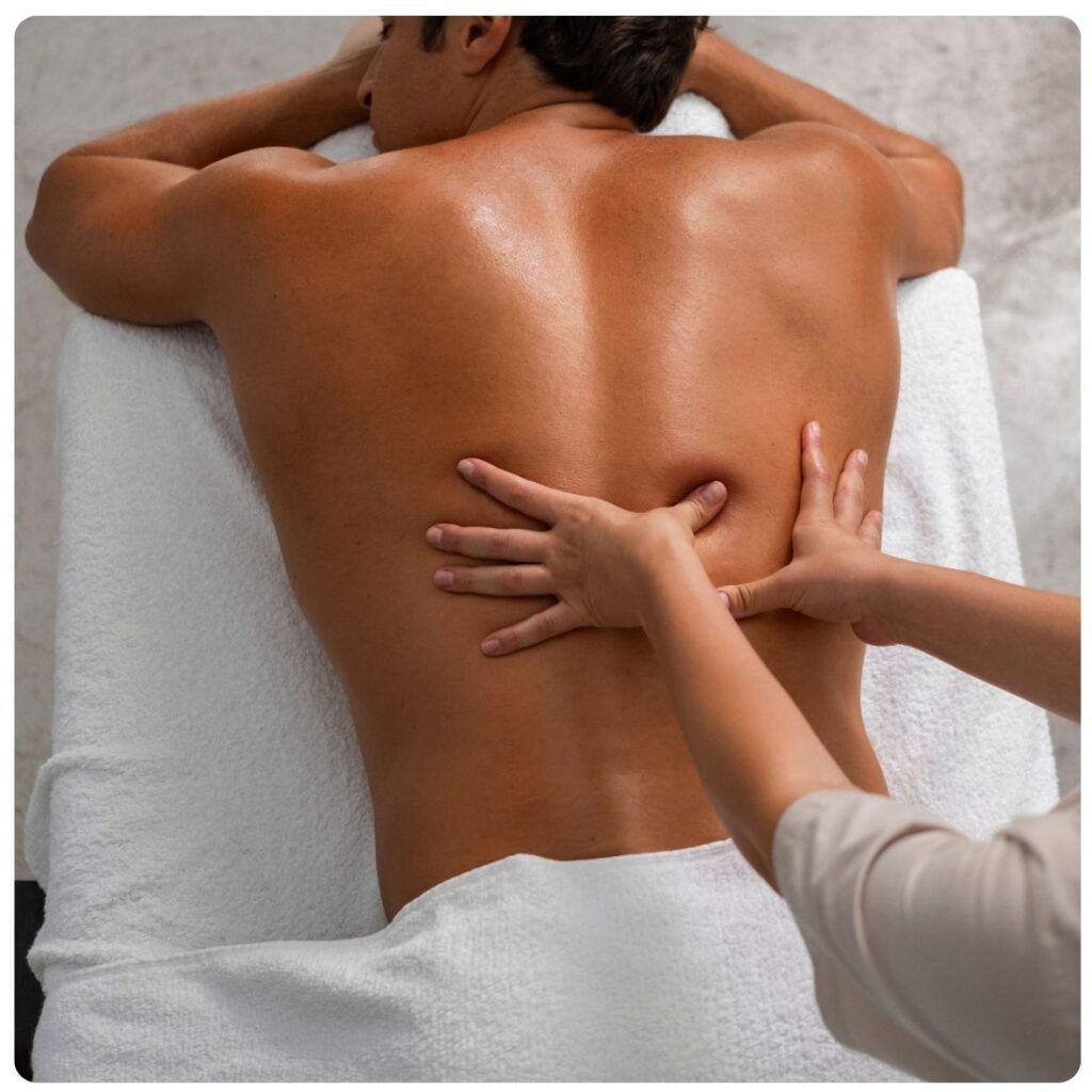 Full Body Massage at The Cupcake Lounge, showing a therapist gently massaging a client's back during a relaxing spa treatment.