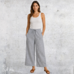 Woman wearing grey pinstripe wide-leg pants with a white sleeveless top and sandals.