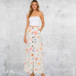 Floral Maxi Skirt featuring a cream background with colourful pink, coral, orange and green floral prints, a button-down front and a flowing floor-length design.