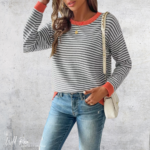 Women’s grey and white striped knitted jersey with contrasting red cuffs and neckline.