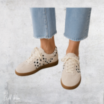 Dalmatian Chic Sneaker in white with black spotted detailing and a gum-coloured sole.