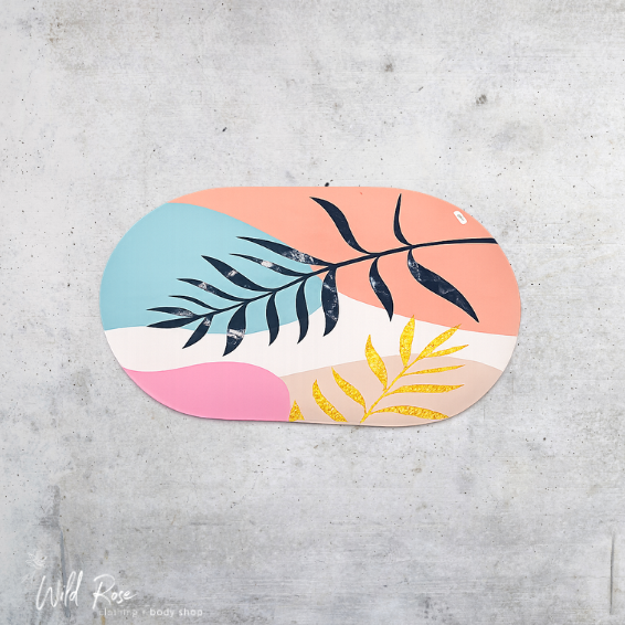 Oval Rubber Bath and Shower Mat with colourful abstract botanical design in pink, peach, blue, white and gold.